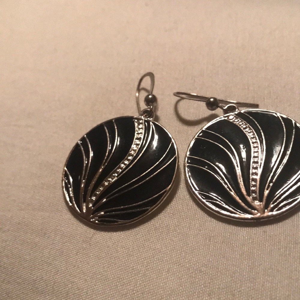 Pair of round black and silver metal earrings